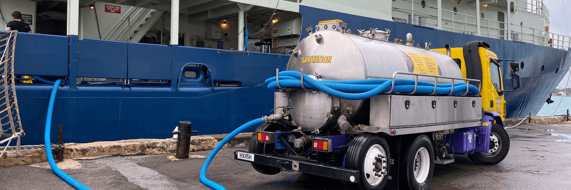 BSE sanitation tanker truck servicing a ship’s waste holding tank in Bermuda